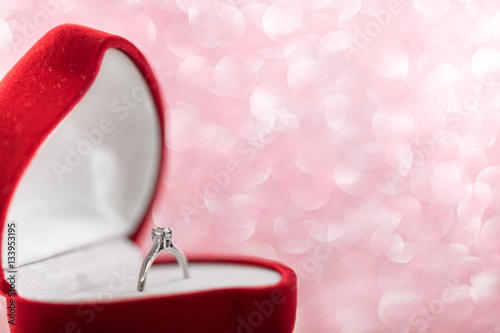 wedding diamond ring in  red heart shaped gift box © producer