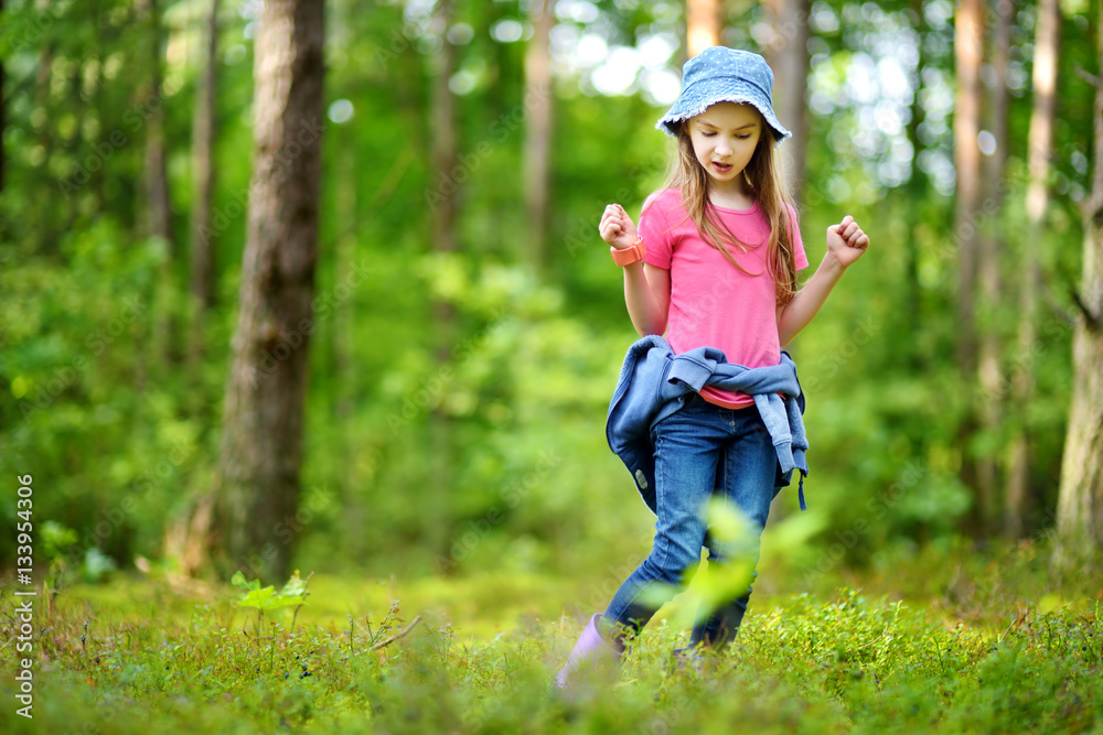 Cute little girl having fun during forest hike Cute little girl having fun during forest hike