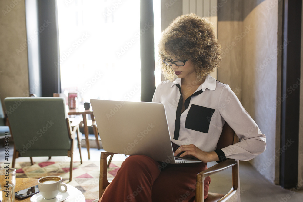 Businesswoman using laptop in hotel lobby Businesswoman using laptop in hotel lobby