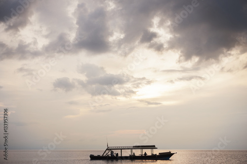Boat sailing on sea against sky at Moyo Island photo