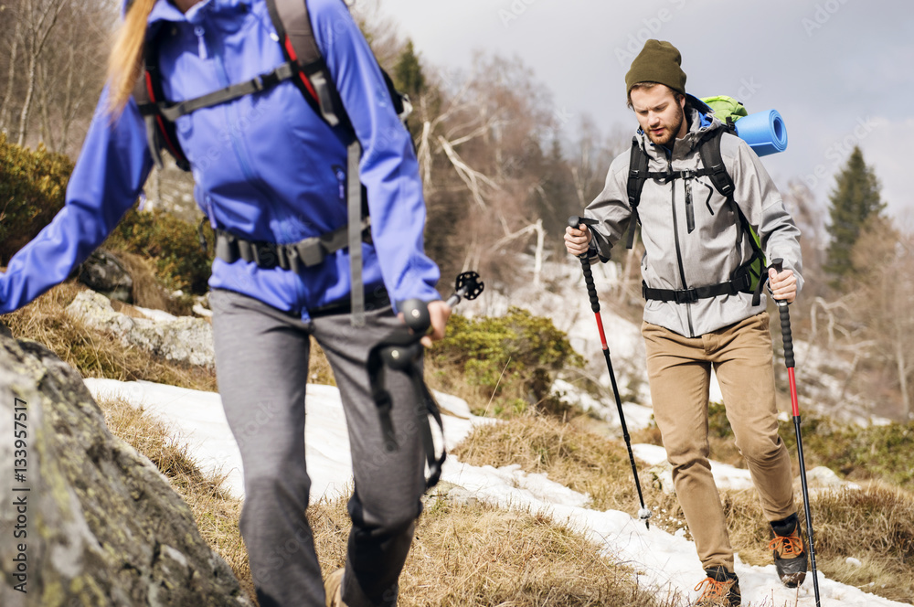 Hikers walking on mountain during winter Hikers walking on mountain during winter