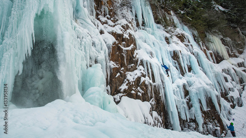 Frozen waterfall with Ice Climber in Background