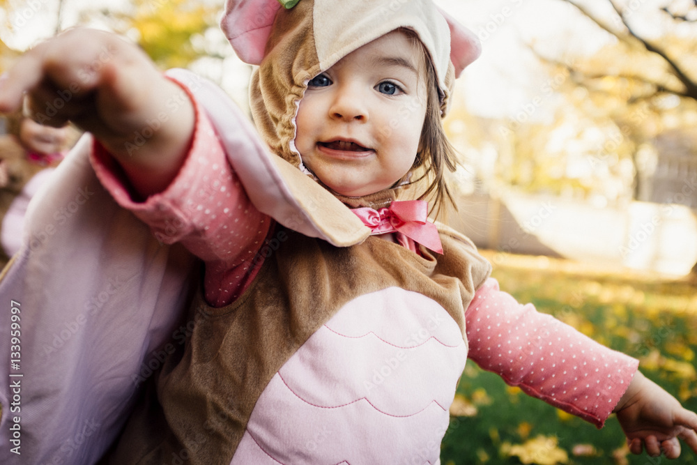 Portrait of cute girl wearing bird costume Stock Photo | Adobe Stock