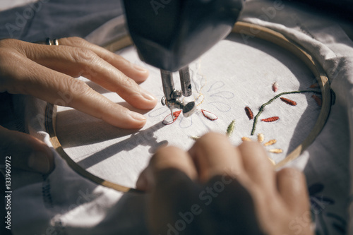 Close up of woman hands embroidering fabric
