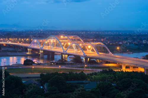 Aerial view of Dong Tru bridge crossing Red River at twilight in Hanoi, Vietnam photo