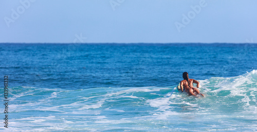 Surfer girl in Amazing Blue water