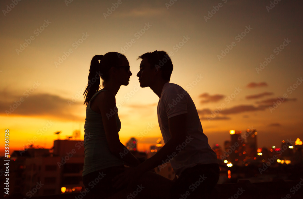 Young couple kissing at twilight. 