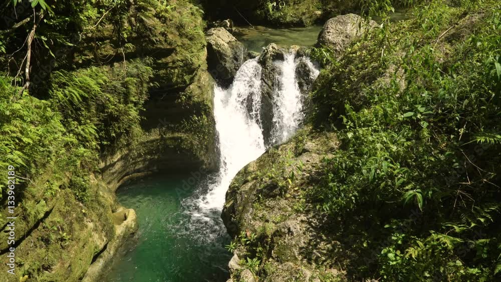 Waterfall in green forest in jungle. Beautiful waterfall in the mountains. Tropical rain forest with waterfall. Philippines, Cebu. 4K video. Travel concept. Waterfall in green forest in jungle. Beautiful waterfall in the mountains. Tropical rain forest with waterfall. Philippines, Cebu. 4K video. Travel concept.
