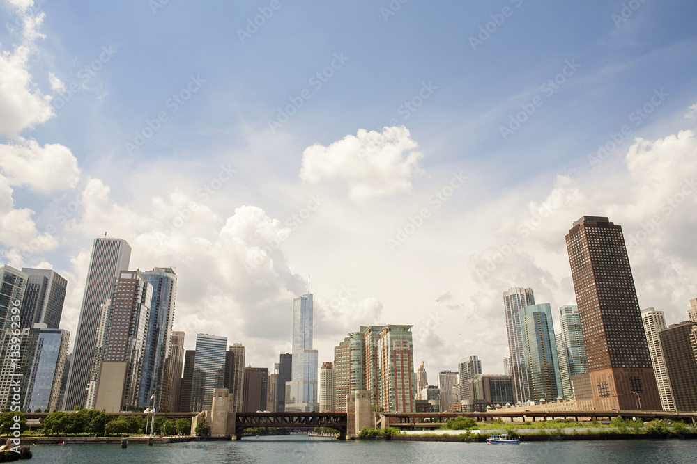 Low angle view of skyscrapers against cloudy sky Low angle view of skyscrapers against cloudy sky