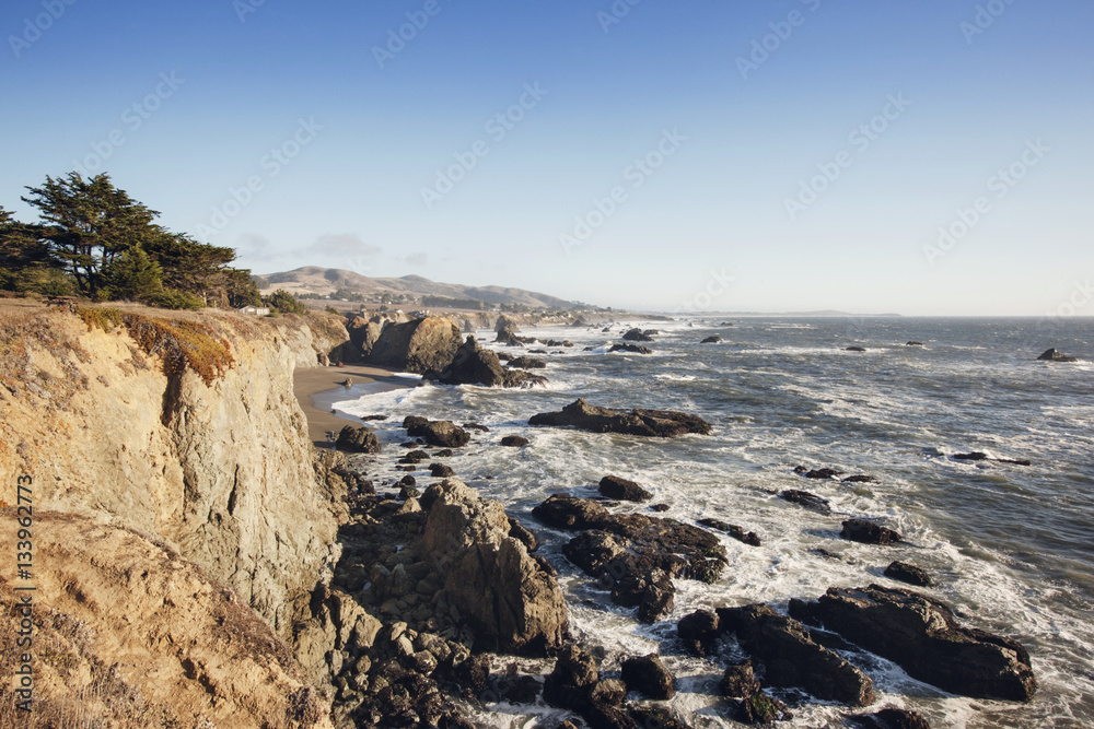 Rocks on beach against clear blue sky Rocks on beach against clear blue sky