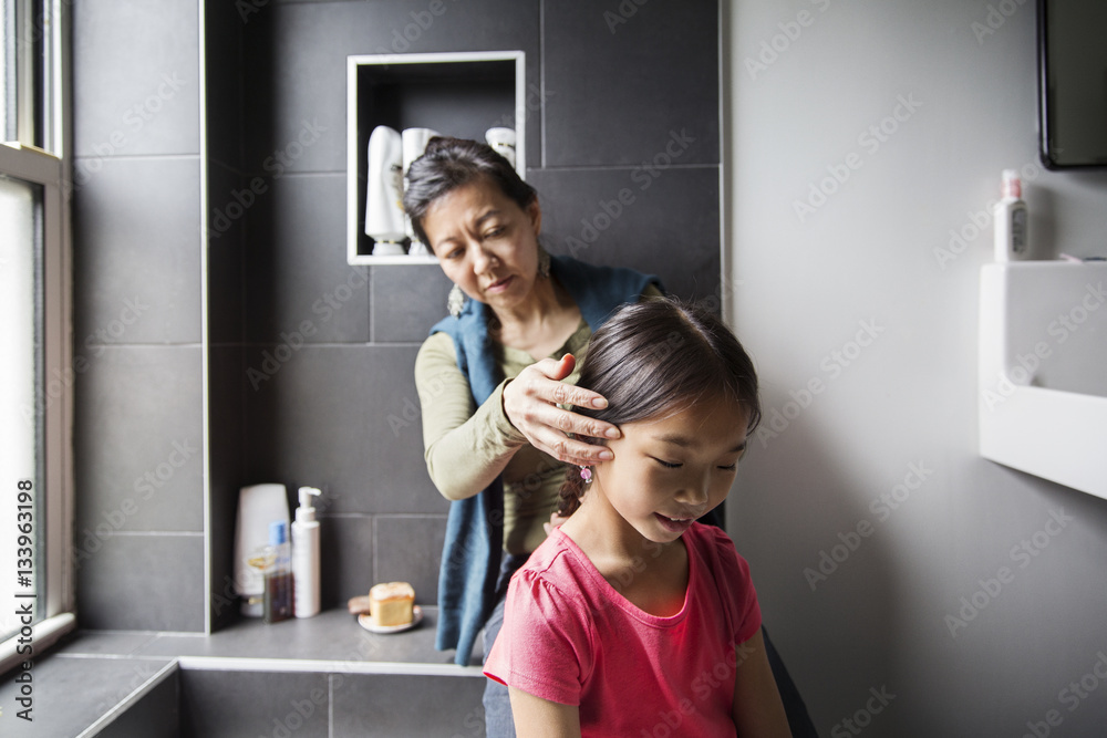 Mother grooming daughter in bathroom Mother grooming daughter in bathroom