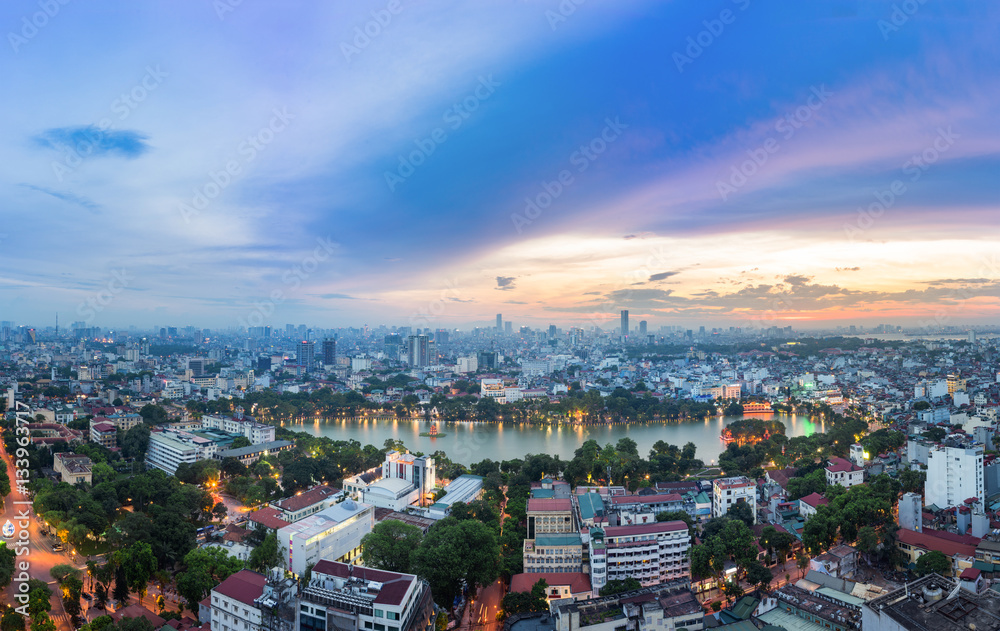 Fototapeta premium Aerial skyline view of Hoan Kiem lake (Ho Guom, Sword lake) area at twilight. Hoan Kiem is center of Hanoi city. Hanoi cityscape.