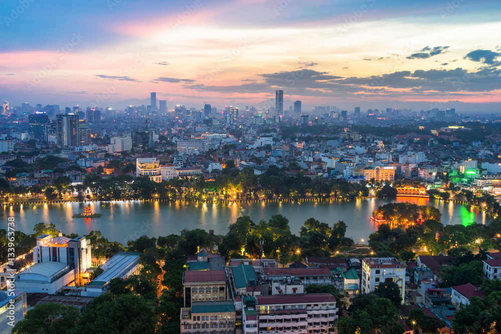 Obraz premium Aerial skyline view of Hoan Kiem lake (Ho Guom, Sword lake) area at twilight. Hoan Kiem is center of Hanoi city. Hanoi cityscape.