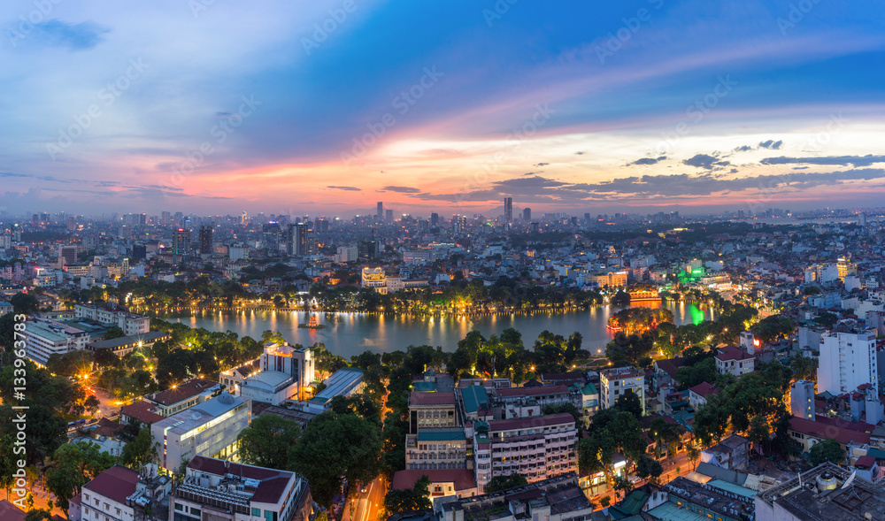 Naklejka premium Aerial skyline view of Hoan Kiem lake (Ho Guom, Sword lake) area at twilight. Hoan Kiem is center of Hanoi city. Hanoi cityscape.