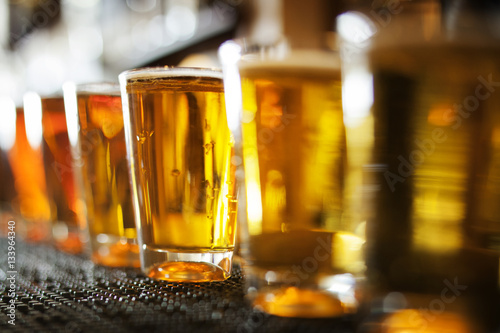 Row of beer glasses on table photo