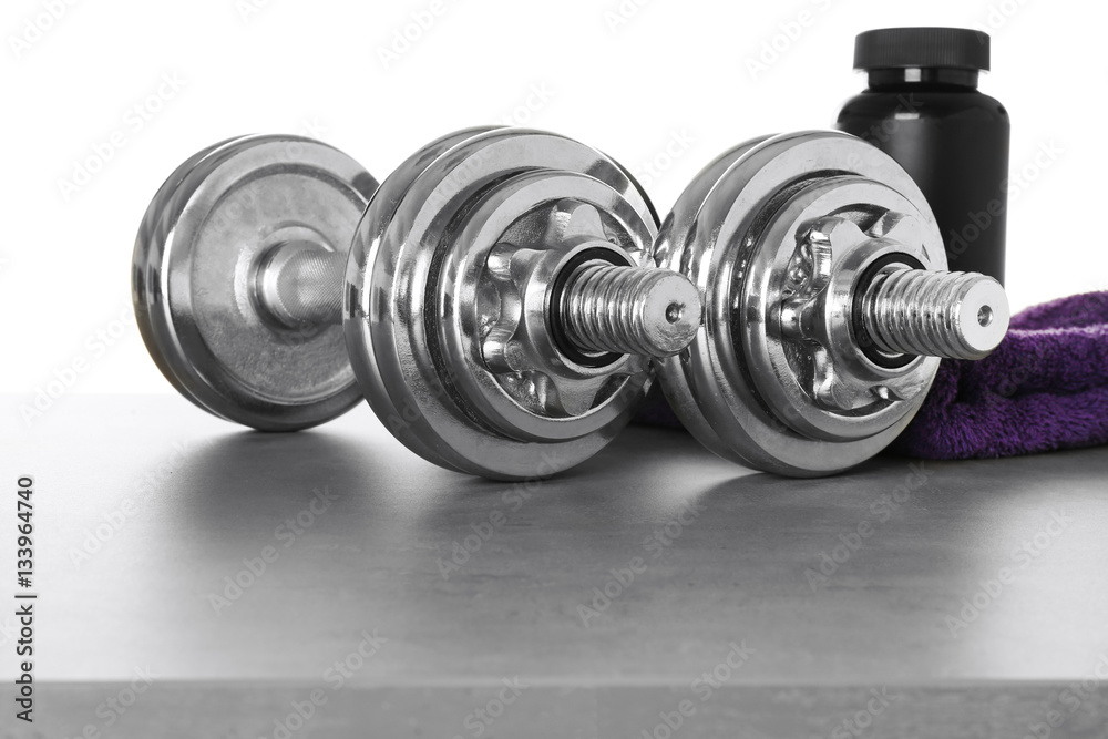 Sports concept. Workout objects on grey table and white background