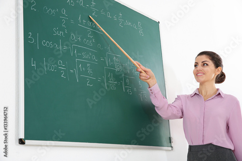 Young female teacher beside...