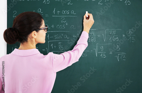 Young female teacher beside...