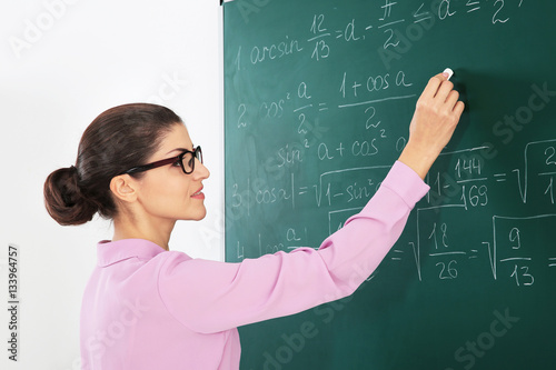 Young female teacher beside...