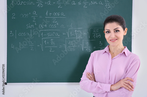 Young female teacher beside...