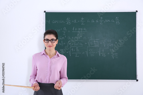 Young female teacher beside...