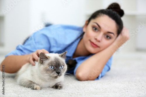 Cute beautiful cat with owner at home