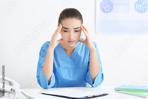 Depressed medical worker in her office