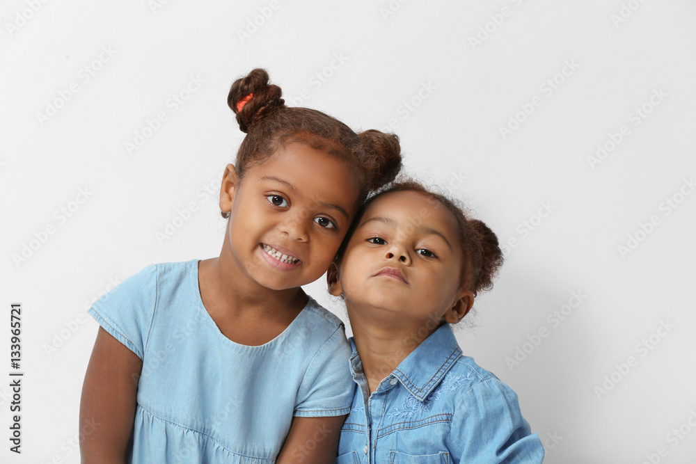 Two cute African girls posing on white background Two cute African girls posing on white background