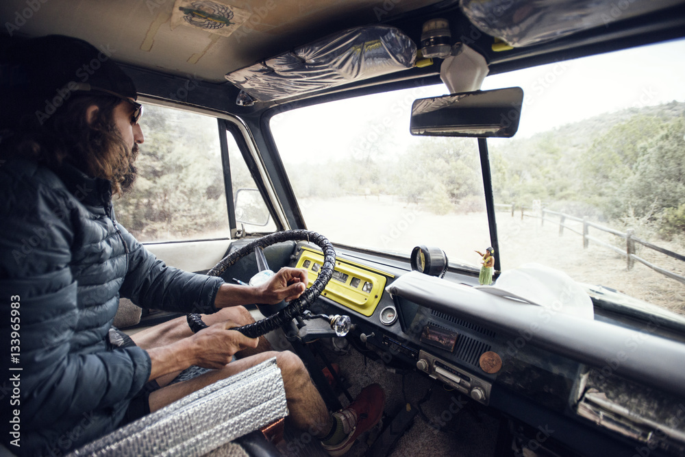 Side view of man driving truck on mountain Side view of man driving truck on mountain