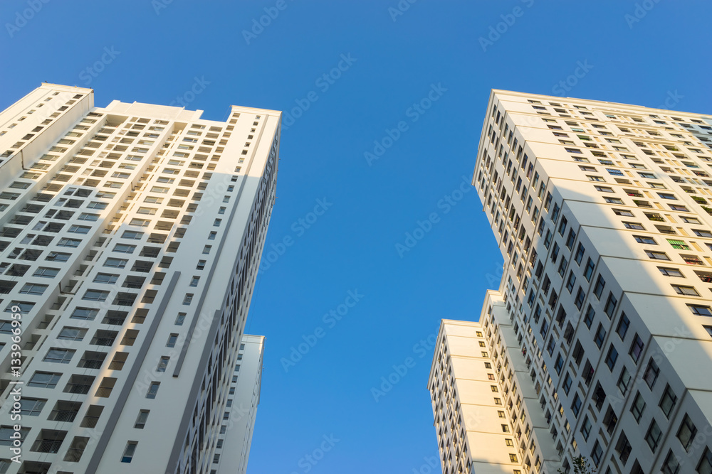 Resident apartment buildings against blue sky. Real estate background Resident apartment buildings against blue sky. Real estate background