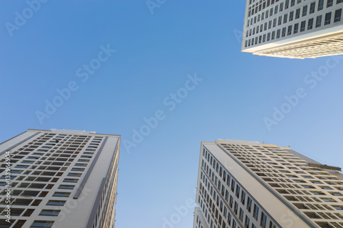 Resident apartment buildings against blue sky. Real estate background