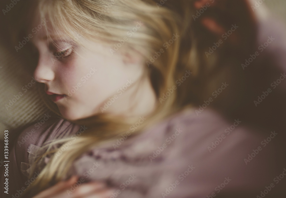 Overhead view of girl sleeping on bed