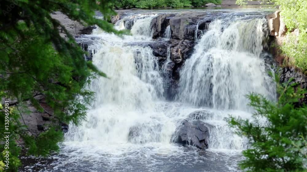 Peaceful nature scene of a waterfall in the woods. Filmed at Gooseberry Falls in Northern Minnesota, USA. With audio. Peaceful nature scene of a waterfall in the woods. Filmed at Gooseberry Falls in Northern Minnesota, USA. With audio.