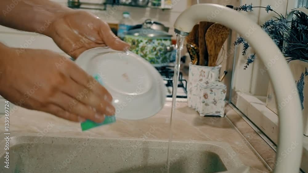 Woman washing her hands with soap on kitchen. Close-up view with side camera motion Woman washing her hands with soap on kitchen. Close-up view with side camera motion