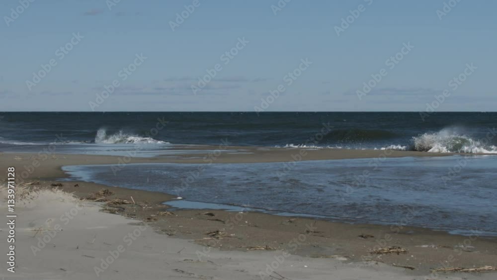 Creeping foam from crashing waves on beach slow motion Creeping foam from crashing waves on beach slow motion