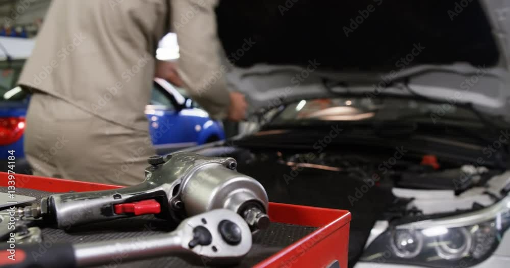 custom made wallpaper toronto digitalMechanic using laptop while servicing a car engine