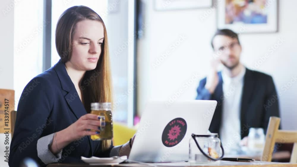 Young Businesswoman Drinking Tea and Smiling Young Businesswoman Drinking Tea and Smiling