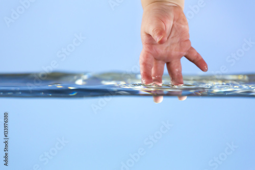 Baby touching water