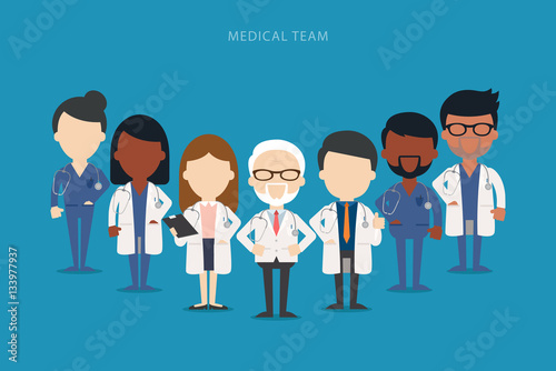 Team of doctors and other hospital workers stand together. 