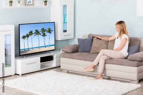Woman Watching Television At Home
