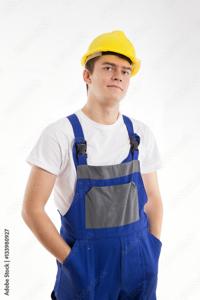 Construction worker standing in a blue suit on a white background Construction worker standing in a blue suit on a white background
