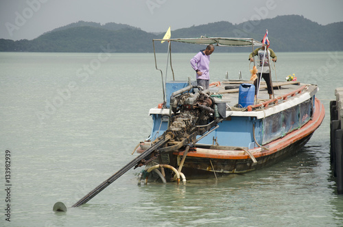 People drive wooden ship and mooring at Koh Yao Noi Harbor for s