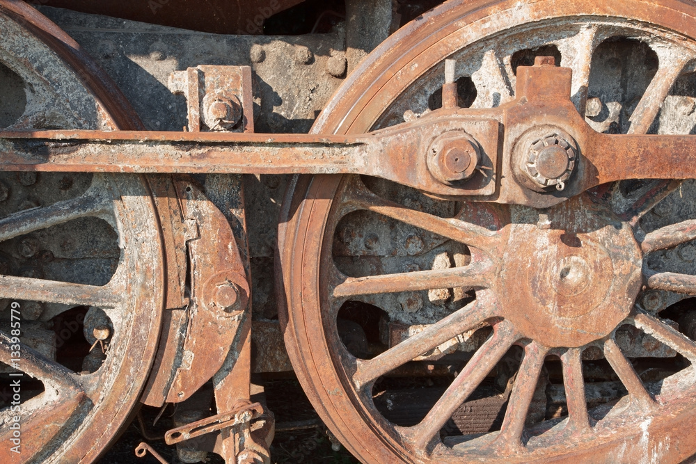 detail of driving rod mechanism in rust on old steam locomotive