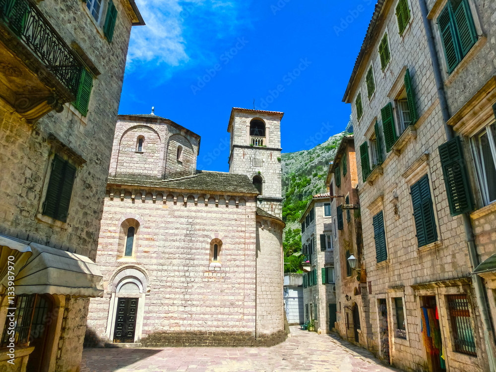 The narrow street in Kotor in a beautiful summer day