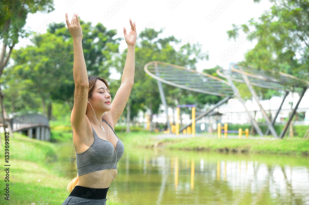 Young Beautiful sporty woman with earphone listen to the nature