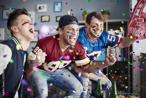 American football fans among falling confetti photo