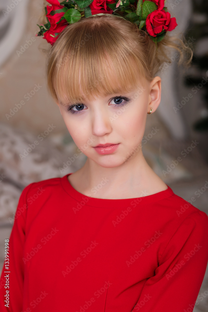 Portrait of a young beautiful blonde in a red dress at the Chris Portrait of a young beautiful blonde in a red dress at the Chris