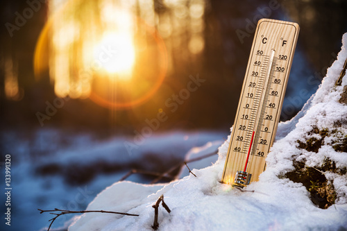 thermometer with low temperature in the snowy woods. Cold weather in the woods