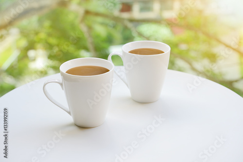 Cup,Two cup, of tea or coffee on table on garden bright backgrou