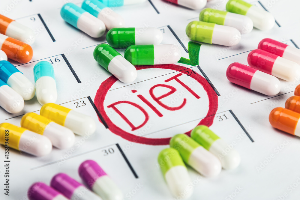 pills of different colors lie on the diet plan. Schedule of pills pills of different colors lie on the diet plan. Schedule of pills